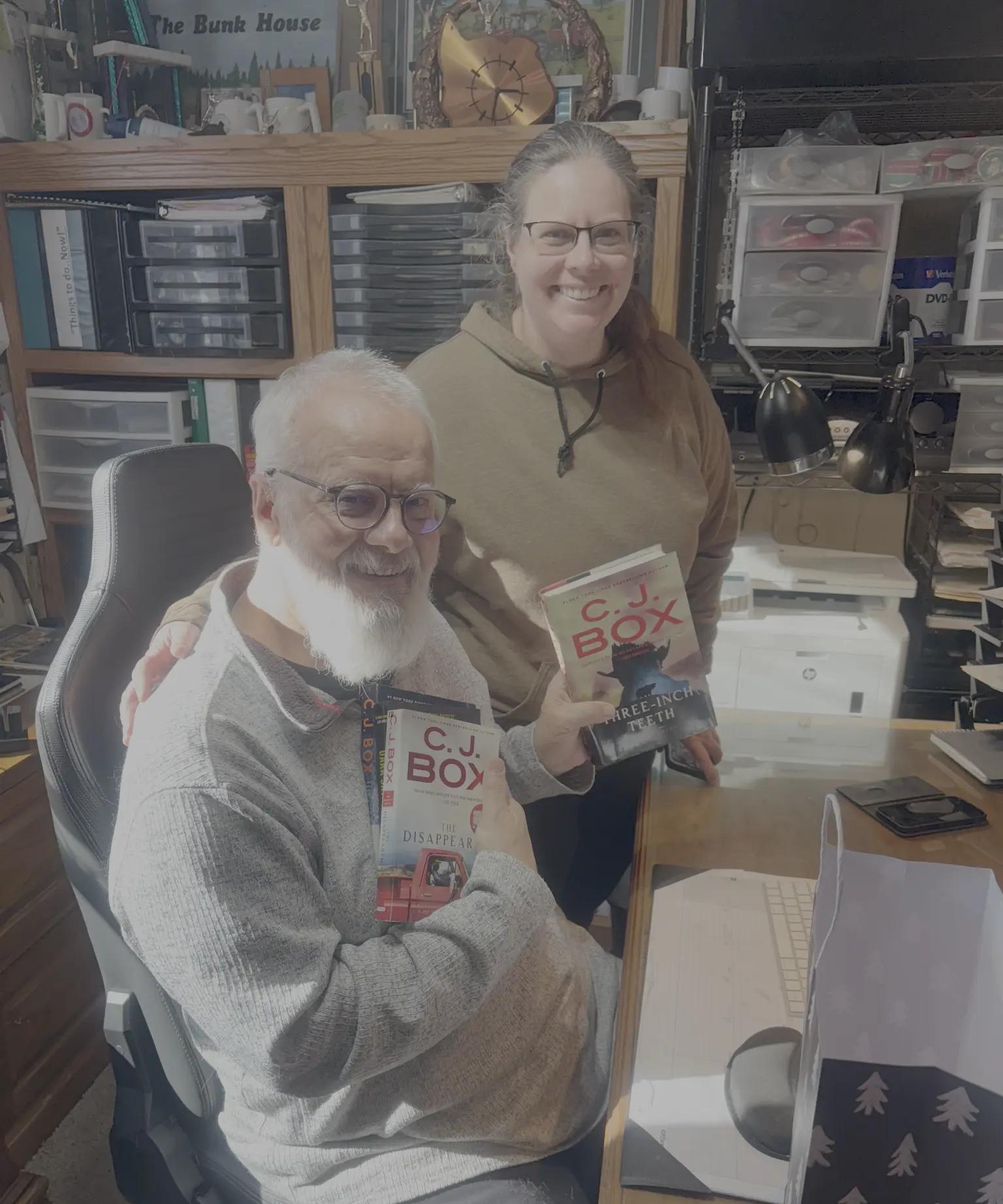 Emily and her father Henry sharing C.J. Box books in their home office
